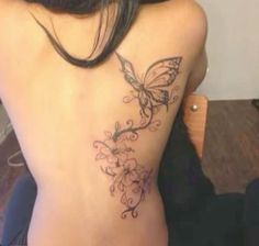 a woman with a butterfly tattoo on her back