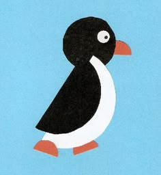 a paper cut out of a black and white bird on a blue background with an orange beak