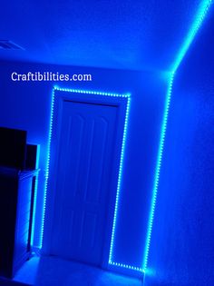 an empty room with blue lights on the walls and a door in the corner that is lit up