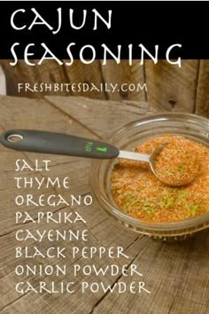 the ingredients for cajun seasoning sit in a glass bowl on a wooden table