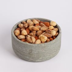 a bowl filled with nuts sitting on top of a table