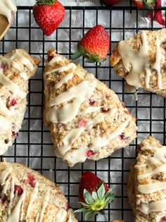 strawberry scones with icing and strawberries on a cooling rack