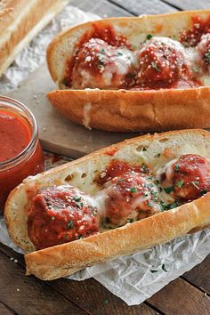 two meatball sub sandwiches with sauce and bread