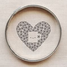 a cross stitch pattern with a heart and flowers in the shape of a cat's head