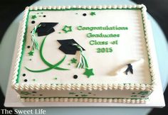 a graduation cake is decorated with green and white frosting