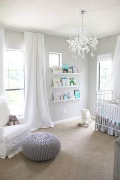 a baby's room is decorated in white and gray