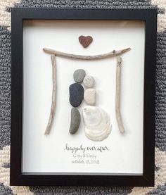 a frame with some rocks and a heart on it