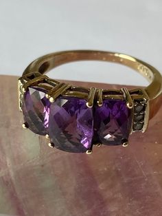 Vintage - Amethyst and Diamond 9ct Gold Three Stone Ring - in a stepped claw setting, with three claw set diamonds either side - c1980's. The three Stone Amethyst is Facet Cut and graduated. Stunning vintage statement ring/ engagment ring - graduation present. Ring Size - N/O UK - US 7 1/4 Luxury Vintage Amethyst Ring With Polished Finish, Luxury Vintage Gold Amethyst Ring, Antique Amethyst Ring Gold, Luxury Antique Amethyst Ring, Classic Three Stone Amethyst Ring For Formal Occasions, Classic Three Stone Amethyst Ring For Anniversary, Formal Three Stone Amethyst Ring, Graduation Present, Graduation Presents