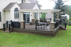 a house with a deck and patio in the front yard