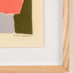 an abstract painting with different colors in a wooden frame