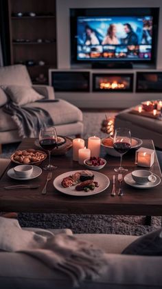 a living room filled with furniture and a flat screen tv sitting on top of a wooden table