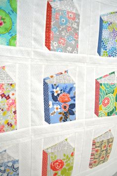 a quilted wall hanging with many different designs on it