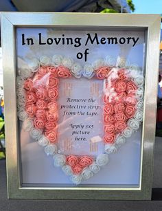 a heart shaped frame with roses in the shape of a heart that reads, in loving memory of