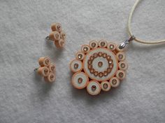 a necklace and earring made out of wood beads on a white surface with a cord