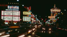 a busy city street filled with lots of neon signs