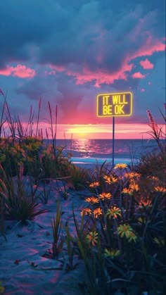 there is a sign that says it will be ok in front of the ocean at sunset