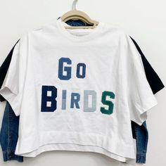 Denim By Murph Eagles Go Birds T Shirt Size Medium Nwt White Denim Short Sleeve Top, White Short Sleeve Denim Tops, Denim Crew Neck Tops With Graphic Print, Trendy Denim Tops With Letter Print, Spring Denim Top With Graphic Print, White Denim Casual Tops, Trendy White Denim Tops, Eagles Shirt, Anchor Shirts