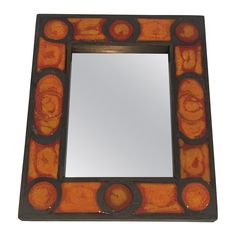 an orange and black mirror with circles around it