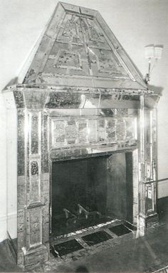 an old fireplace has been decorated with mosaic tiles