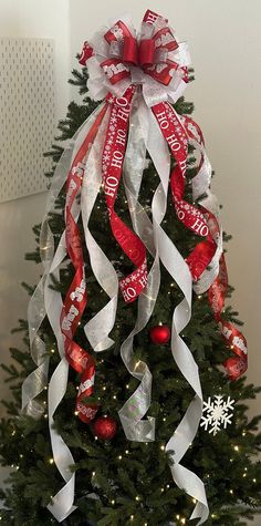 a christmas tree decorated with ribbons and ornaments