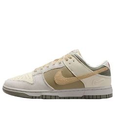 The Nike Dunk Low combines retro flair with modern comfort. Crafted from a mix of leather and textile, these kicks pay homage to '80s basketball aesthetics. The padded, low-cut collar ensures all-day comfort, whether you’re hitting the court or strolling the streets. The colorway features a sophisticated blend of Coconut Milk, Sesame, Alabaster, Light Bone, Neutral Olive, and Dark Stucco. With its extra Swoosh on the heel, this Dunk Low is a stylish nod to the past, perfect for sneaker enthusias Retro Nike Skate Shoes With Gum Sole, Nike Retro Skate Shoes With Gum Sole, Nike Throwback Streetwear Skate Shoes, Retro Basketball Shoes With Gum Sole And Round Toe, Retro Basketball Shoes With Gum Sole, Vintage Basketball Shoes With Boost Midsole For Streetwear, Nike Retro Skate Shoes For Streetwear, Nike Retro Sneakers For Skateboarding, Retro Basketball Shoes With Speckled Midsole For Streetwear