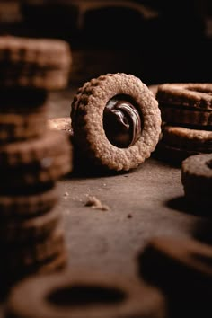 some cookies are sitting on the ground with chocolate frosting in it's center