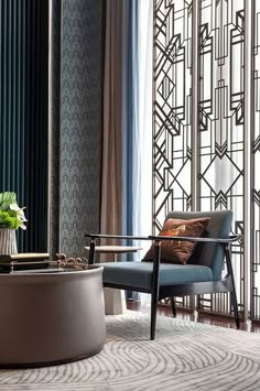 a living room filled with furniture next to a tall glass wall covered in art deco