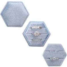 three rings are sitting in a ring box on a white surface with blue velvet hexagons