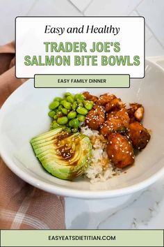 a white bowl filled with rice, meat and vegetables next to an avocado