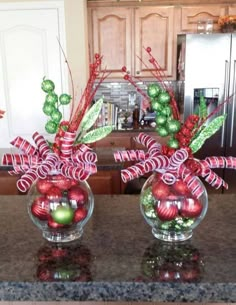 two glass vases filled with candy canes on top of a granite countertop