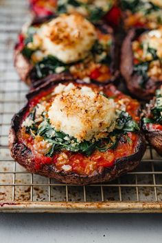 baked stuffed mushrooms with spinach and cheese on a cooling rack, ready to be eaten