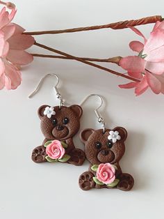 Cute brown bear earrings holding a pink rose with silver micro beads, and they are adorned with a white daisy on the head. They are very cute in real, and so lightweight that it is so easy to use everyday. Perfect for any occasion, style or outfit.  The earrings are made of polymer clay. Though polymer clay is a sturdy material, I still suggest to handle your earrings with care. The earrings are similar but not the same as it is handmade. There will be flaws in the clay, dainty imperfections, du Cute Clay Drop Earrings, Cute Polymer Clay Earrings For Valentine's Day, Cute Brown Dangle Earrings, Cute Polymer Clay Flower Earrings For Gifts, Cute Pink Polymer Clay Earrings, Cute Brown Earrings Gift, Cute Brown Earrings As Gift, Cute Brown Earrings For Gift, Cute Polymer Clay Flower Earrings