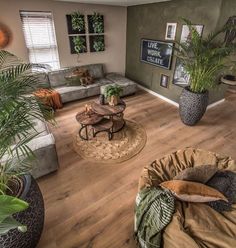 a living room filled with furniture and lots of plants