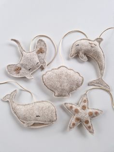 four sea animals made out of felt sitting on top of each other