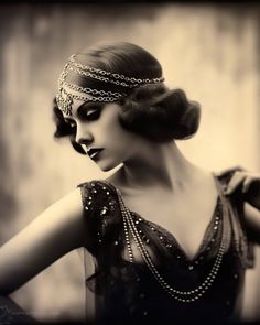 a woman wearing a head chain with pearls on it's neck and her hands behind her back