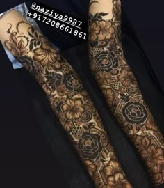 two hands with henna tattoos on them, one has flowers and the other has leaves