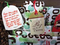 christmas presents wrapped in wrapping paper and decorated with holiday cards, tags and handwritten greetings