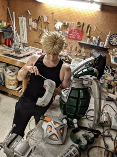 a man working on some kind of machine in a room filled with tools and supplies