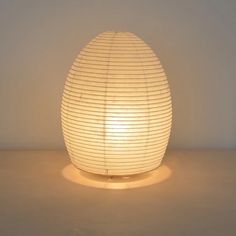 an egg shaped lamp sitting on top of a table