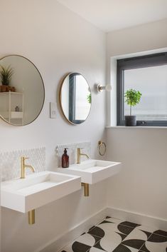 there are two sinks in the bathroom with mirrors above them