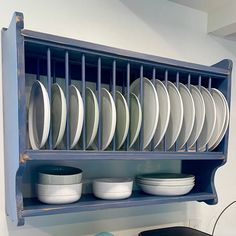 a blue shelf filled with plates and bowls