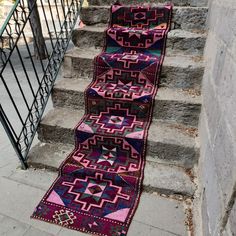 the stairs are decorated with colorful rugs on them