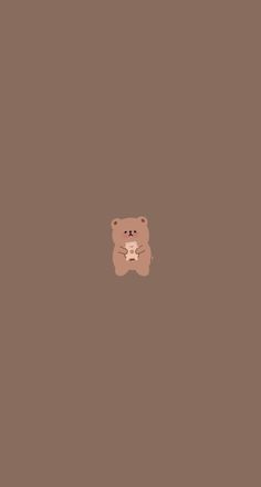 a brown teddy bear sitting on top of a floor