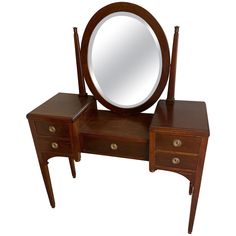 a wooden dressing table with a mirror on it's top and two drawers underneath