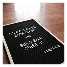 a sign on the ground that says, encourage each other and build each other up