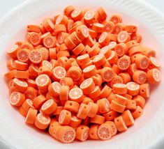 a white bowl filled with orange slices on top of a table