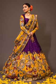 Purple base attached cancan lehenga with women kalamkari hand painted patterns and embroidery. Paired with padded purple blouse embroidered with glass beads and yellow printed dupatta. - Aza Fashions Kalmkari Pattern Lehenga, Full Hands Blouse Designs For Lehenga, Yellow And Purple Lehenga, Luxury Floor-length Kalamkari Print Dupatta, Traditional Silk Lehenga Designs, Kalamkari Painting Saree, Kalamkari Lehangas Designs, Half Saree Lehenga Simple, Multicolor Dola Silk Pre-draped Saree For Wedding