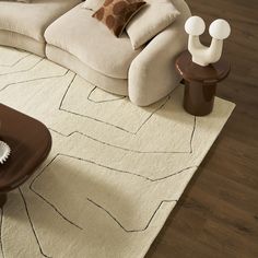 a living room with white furniture and brown accessories