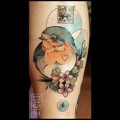 a small bird with flowers on it's thigh is shown in this tattoo design