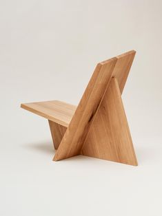 a small wooden chair sitting on top of a white floor